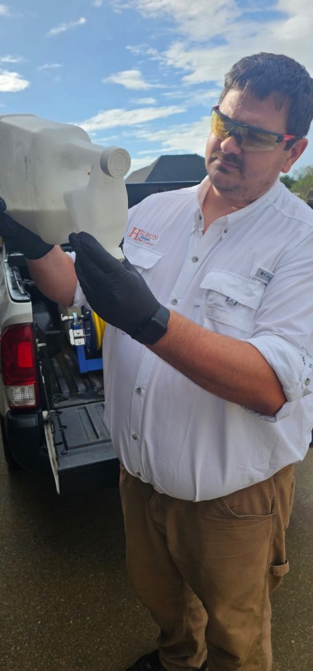 Preparing Bifenthrin for Pest Control Service Hilbun Pest Control technician measuring bifenthrin before a residential pest control treatment.