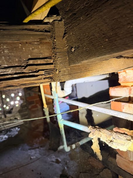 Termite Damage Found During Crawl Space Inspection Termite-damaged wood and exposed plumbing discovered during an inspection underneath a home.